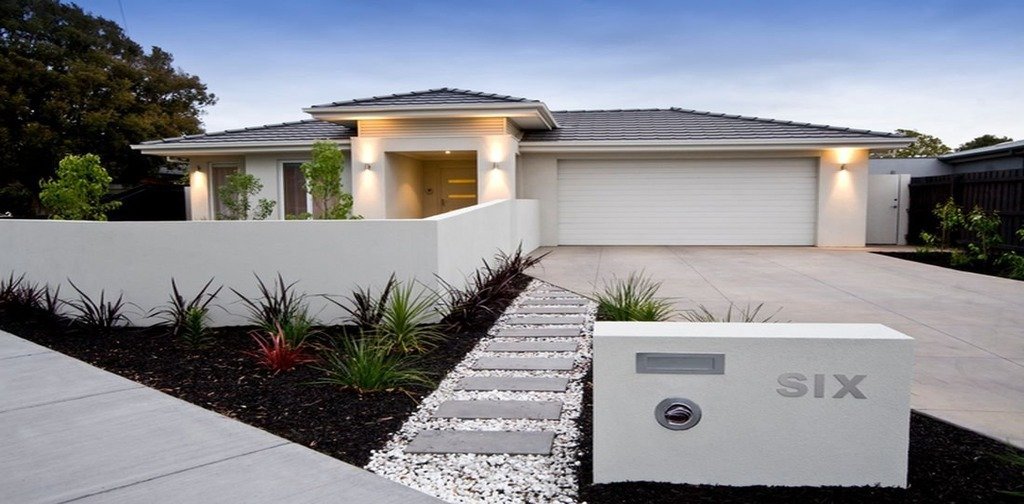 Light-coloured rendered house façade and boundary walls